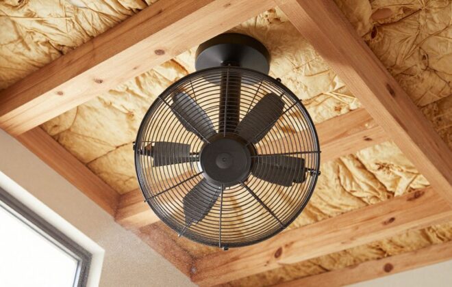 Attic fan installed in a bright, modern attic space.